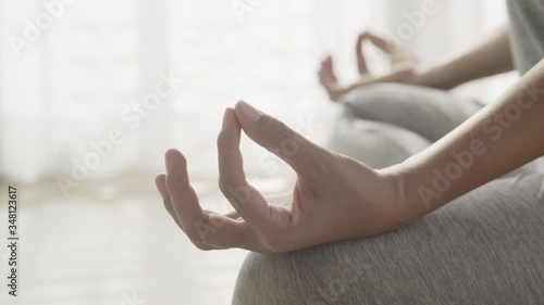Wallpaper Mural Hand of women in lotus pose while sitting at the floor and curtain white in the morning sunlight at home. Dolly shot, Concept of relaxation and meditation Torontodigital.ca