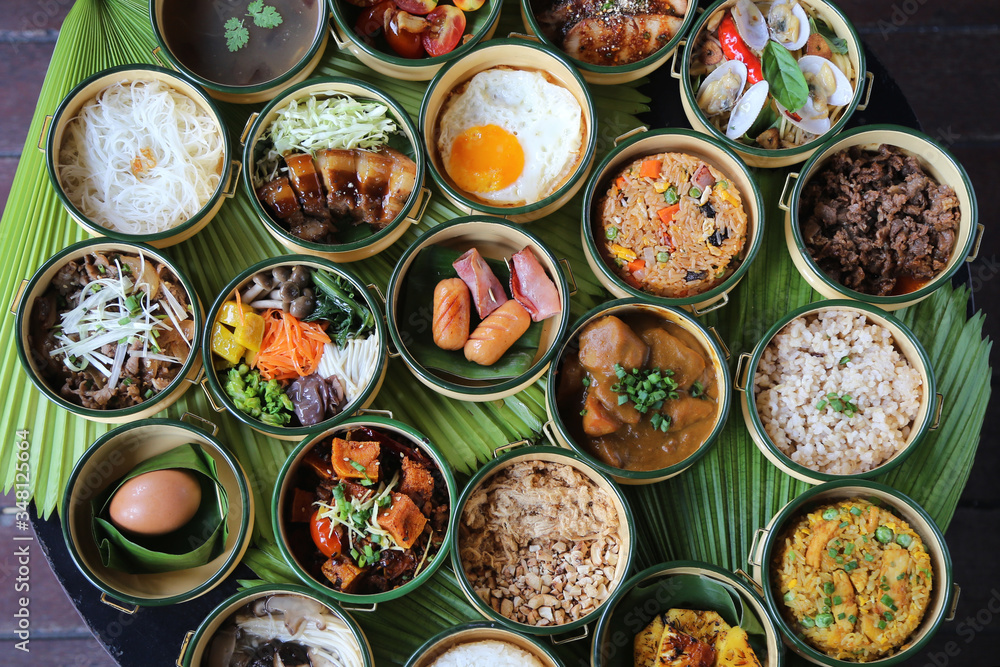 Variety of tasty Asian dishes top view packed on leaf background Variety of tasty Asian dishes top view packed on leaf background