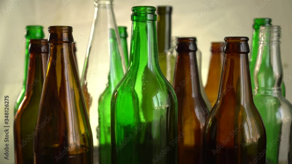 Glass waste sorting, collecting and recycling. Isolated clear coloured and colourless glass bottles, jars, phials Glass waste sorting, collecting and recycling. Isolated clear coloured and colourless glass bottles, jars, phials