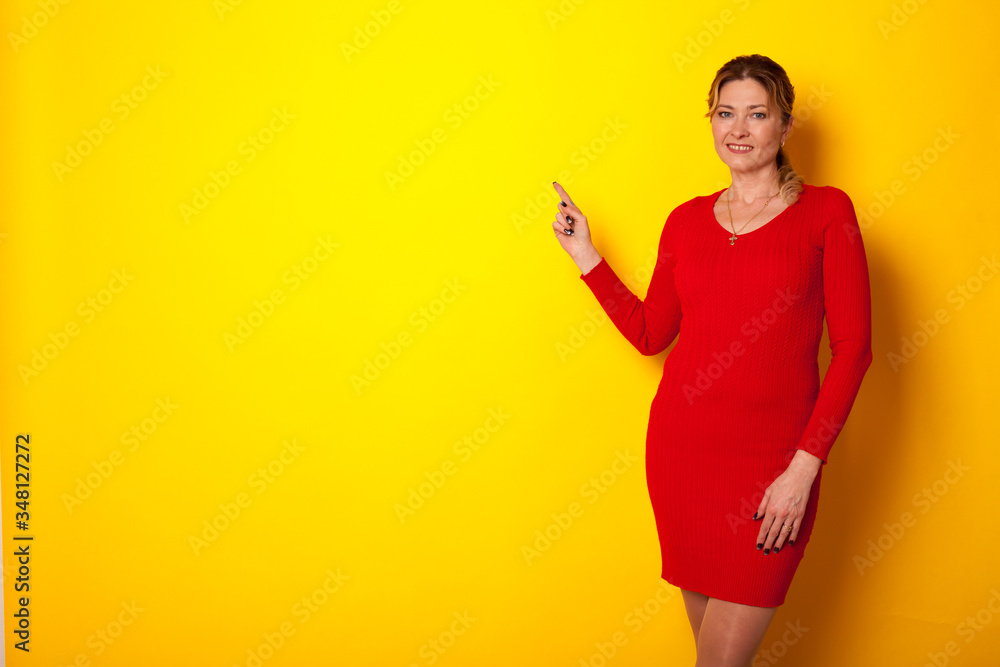 woman forty years in a dress on a yellow background woman forty years in a dress on a yellow background