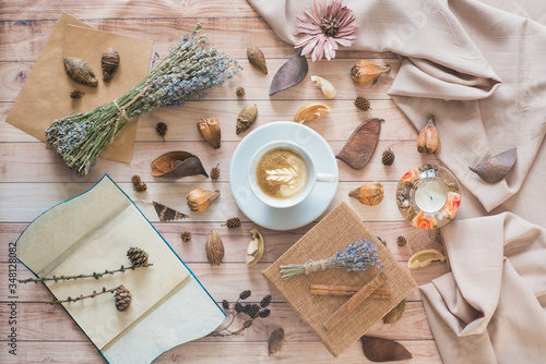 Coffee cup flat lay on wooden background. Cozy autumn composition with details of still life. Autumn mood.