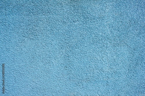 Blue painted wall with rough surface texture background.