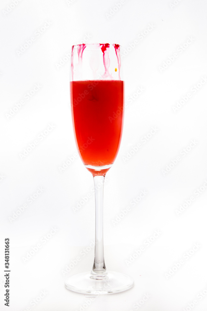 colored water in a glass on a white background. bright colors contrast colored water in a glass on a white background. bright colors contrast