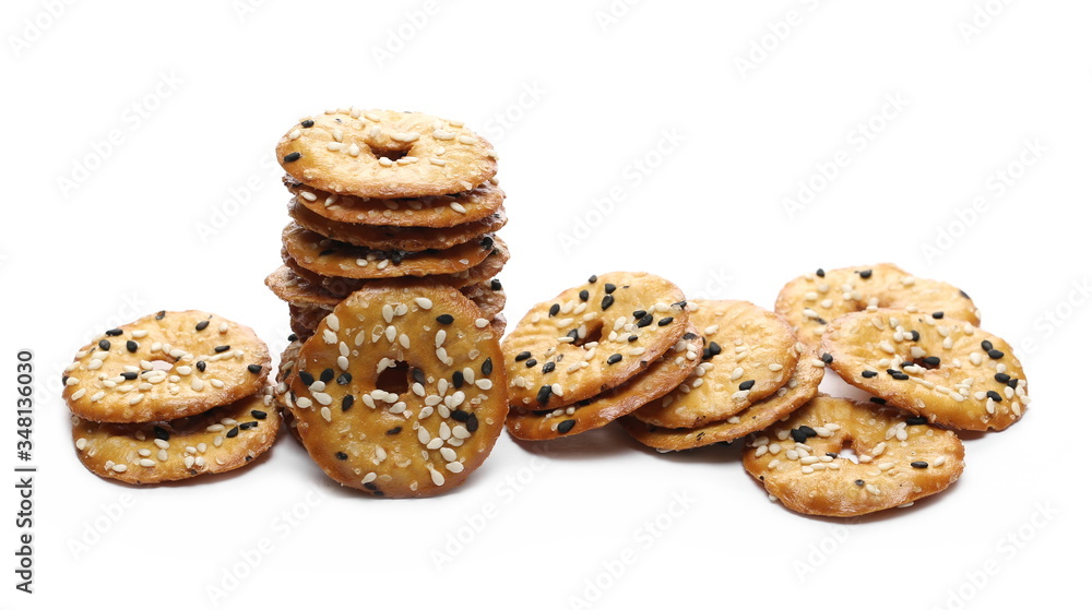 Baked pretzels with black and white sesame seeds, savory snacks isolated on white background