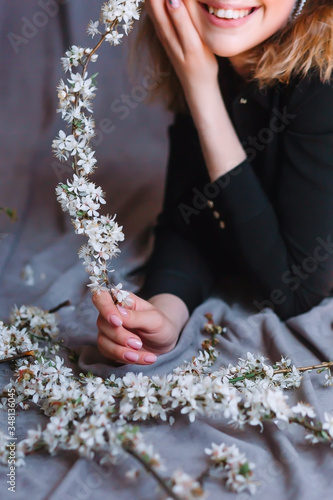 young woman holds a flowering branch