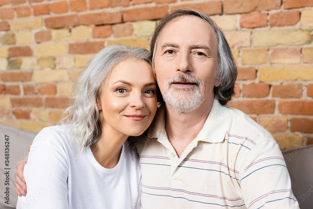 happy middle aged man and woman looking at camera happy middle aged man and woman looking at camera