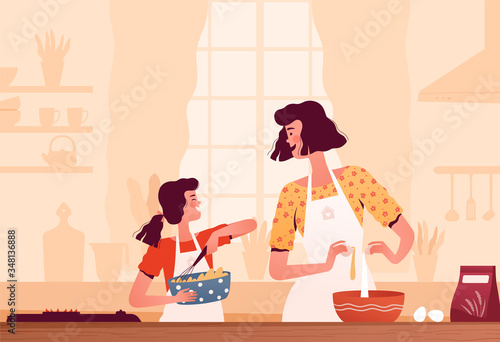 Cheerful mom and daughter cook together at home in the kitchen. The concept of happy motherhood and joint activities with children