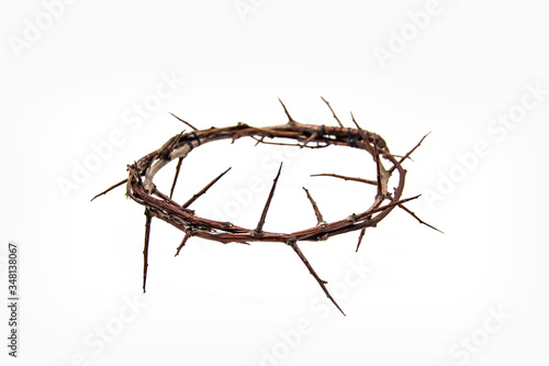 A crown of thorns on a white background. Conceptual phototo use in the design. A wreath of branches with thorns