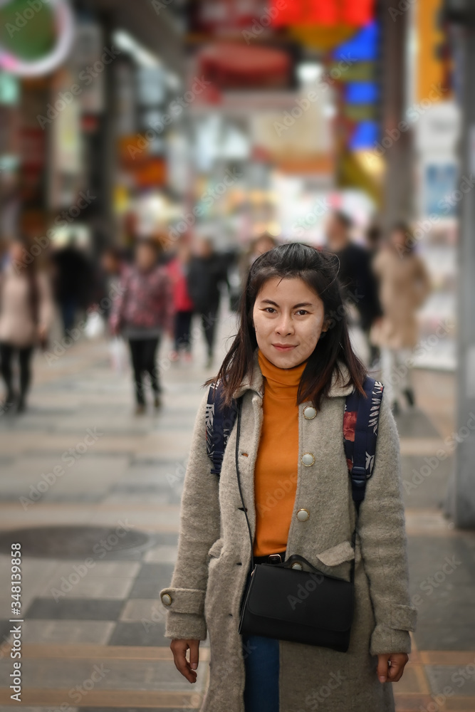 Traveller female posting on shopping street market in Osaka Japan.