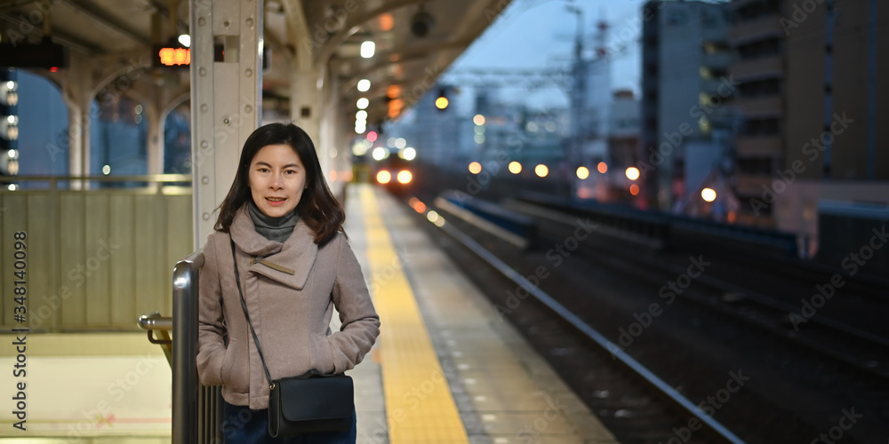 Traveller female posting on train station in kansai Japan.