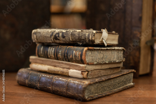 Stack of antique aged books on wooden table