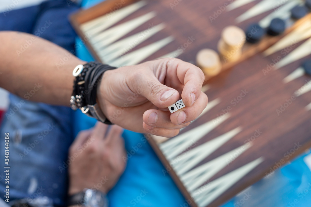 Two friends playing backgammon at home