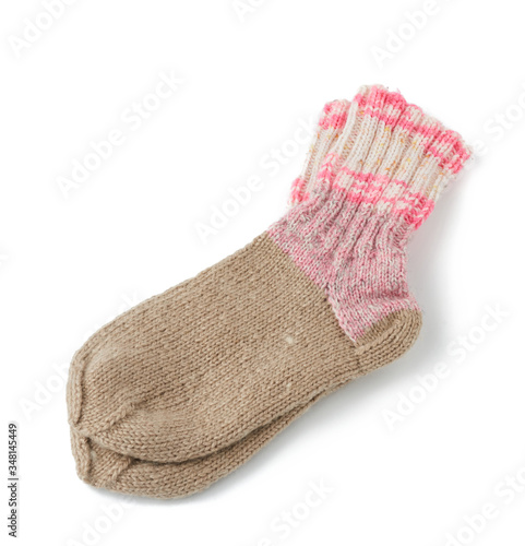pair of striped handmade knitted warm socks made of sheep’s wool yarn