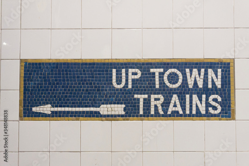 Photography Sign and direction arrow for up town trains in New York City