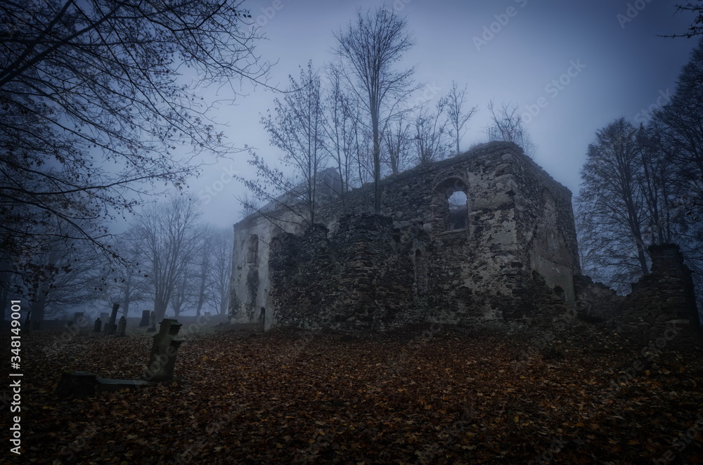 Abandoned and decayed church on a graveyard