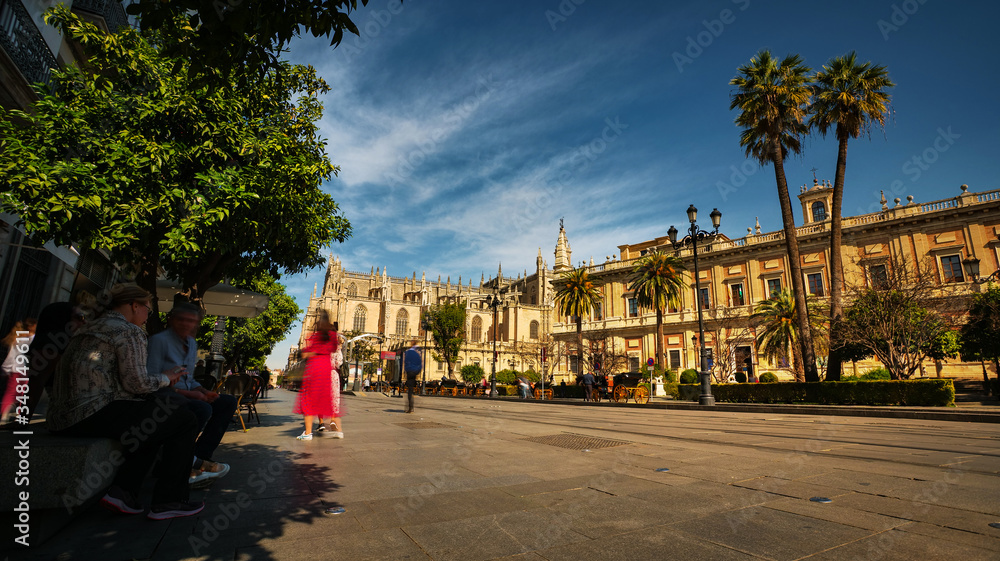 Fototapeta premium Seville, Spain - February 18th, 2020 - the Constitution Avenue near the Seville Cathedral and General Archive of the Indies in Seville, Spain.