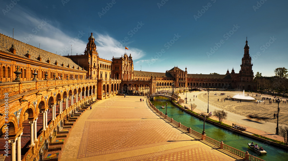 Seville, Spain - February 18th, 2020 - Plaza de Espana / Spain Square in Seville City Center with Architecture Details, Horse Carriages and centered Fountain.