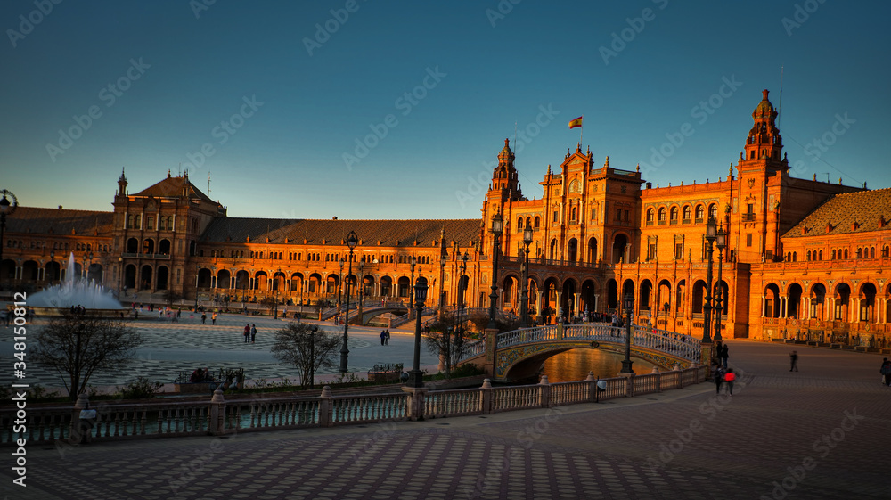 Seville, Spain - February 18th, 2020 - Spain Square (Plaza de Espana) with beautiful bridges and centered Vicente Traver fountain in Seville, Spain.