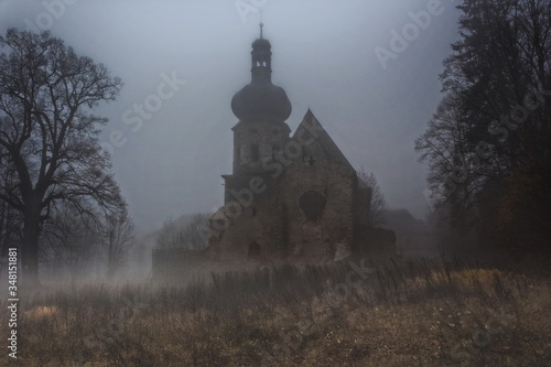 Abandoned and decayed church in the fog