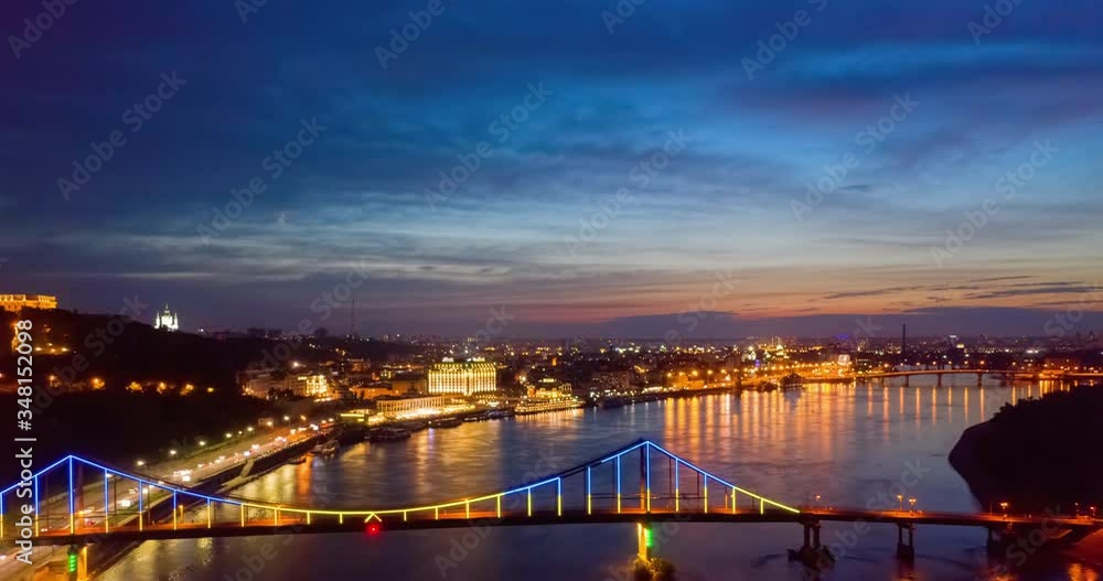 4K UHD Hyperlapse time-lapse of car traffic and people crossing road at night in in Kyiv. colorful led bridge across river and quay road 4K UHD Hyperlapse time-lapse of car traffic and people crossing road at night in in Kyiv. colorful led bridge across river and quay road
