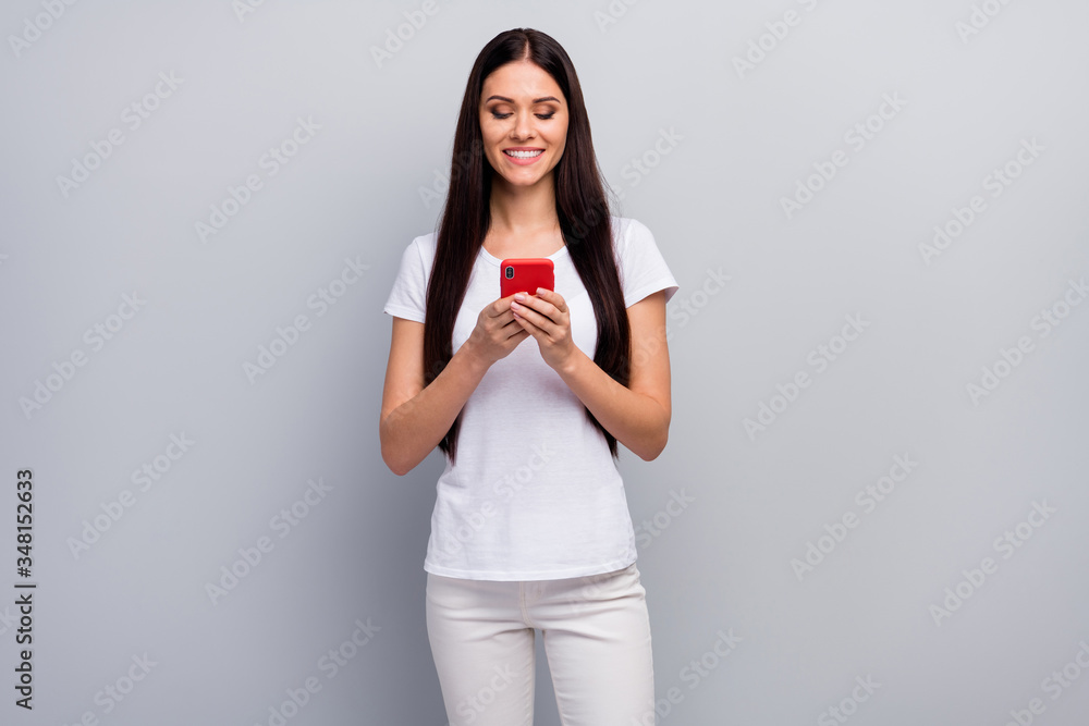 Portrait of her she nice attractive lovely winsome charming cheerful cheery straight-haired girl holding in hands using cell browsing web isolated over light gray pastel color background Portrait of her she nice attractive lovely winsome charming cheerful cheery straight-haired girl holding in hands using cell browsing web isolated over light gray pastel color background