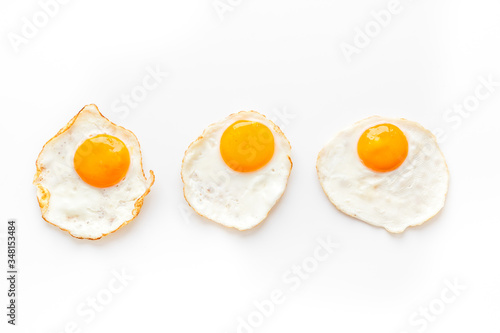 Fried eggs pattern on white background top view