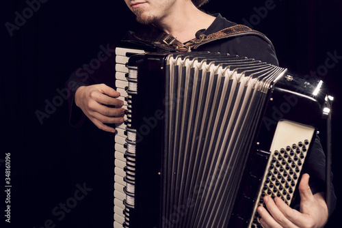 Detail of hands playing an accordion instrument