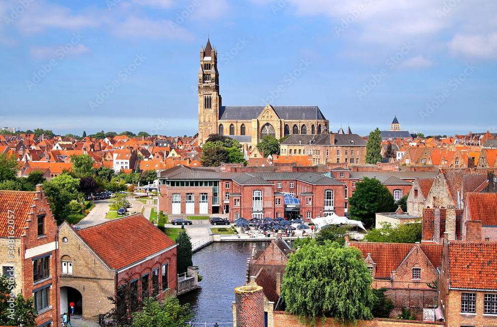 Bruges, Belgium. Bruges city panorama overlooking the Cathedral of St. Salvador, tiled roofs and water canal