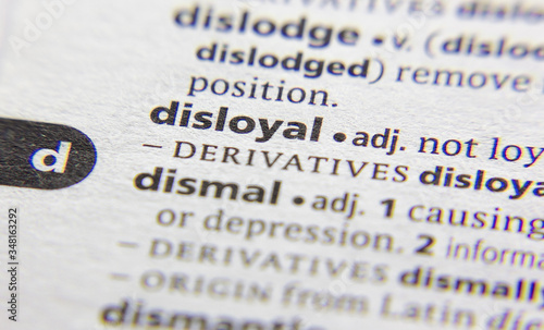 Fotografía Disloyal word or phrase in a dictionary.