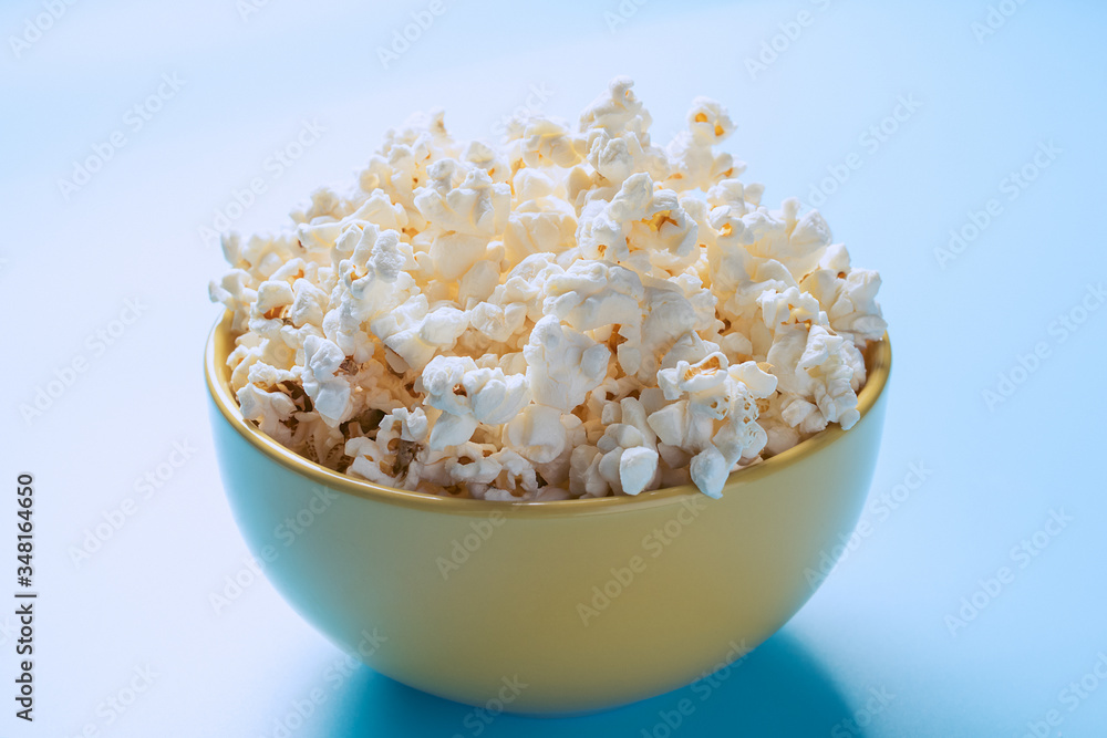 Popcorn in a cup is illuminated by a beautiful light.