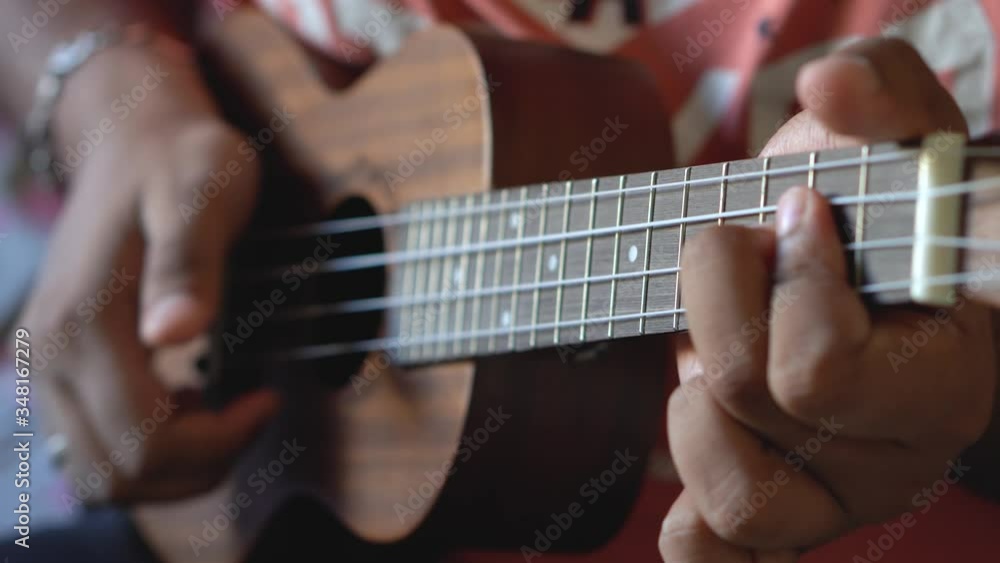 Guy Practicing Ukelele During Quarantine Self Isolated. Guy Practicing Ukelele During Quarantine Self Isolated.