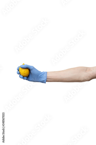 lemon held in hand isolated on white background. man wearing blue gloves holding fresh citrus fruit. delivery during quarantine of coronavirus pandemic COVID-19. food supplies, donation, volunteer