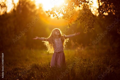 baby girl angel dancing spinning at sunset © AnastasiaKharichkina