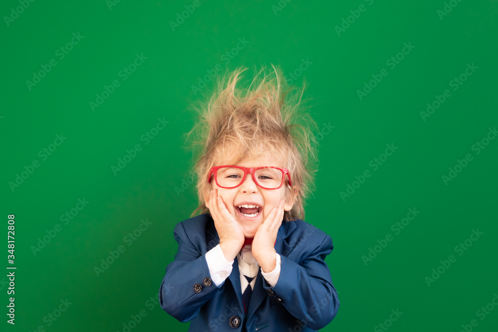 Bright idea! Happy child student against green chalkboard Bright idea! Happy child student against green chalkboard