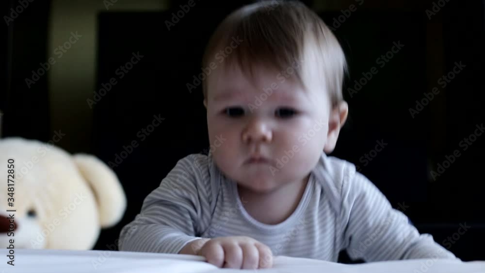little emotional caucasian boy infant looking at the camera with brown big eyes, background little emotional caucasian boy infant looking at the camera with brown big eyes, background