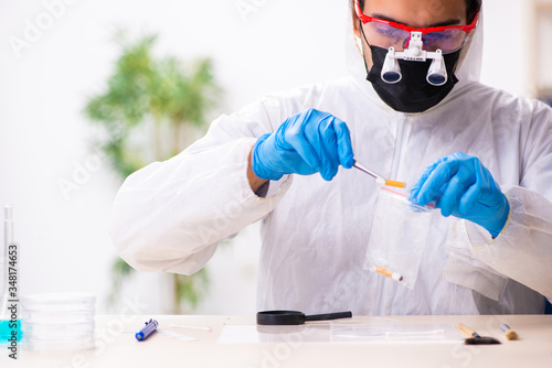 Male expert criminologist working in the lab for evidence