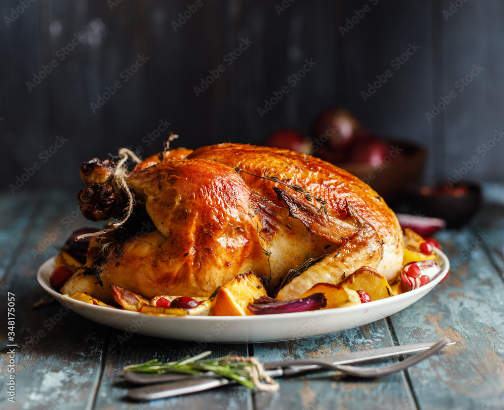Roast whole chicken with roast vegetables on plate on a table Stock Photo Adobe Stock