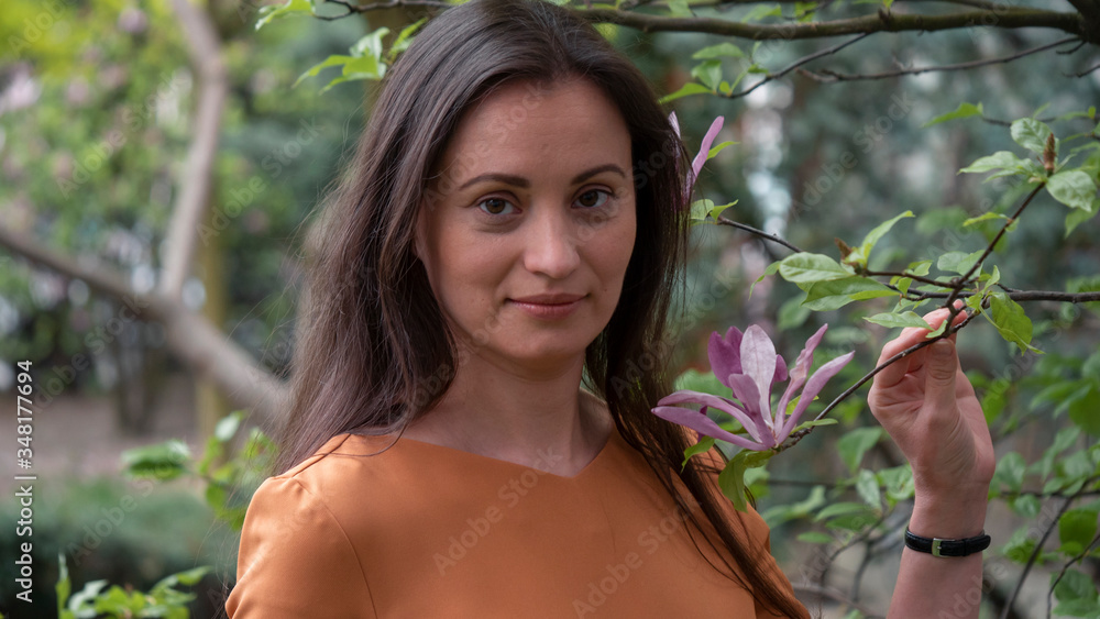 Close-up portrait of beautiful caucasian woman in orange dress. Close-up portrait of beautiful caucasian woman in orange dress.