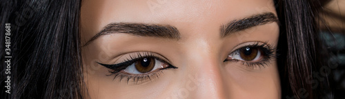 close-up photo of woman eye with eyeliner makeup   on white background.
