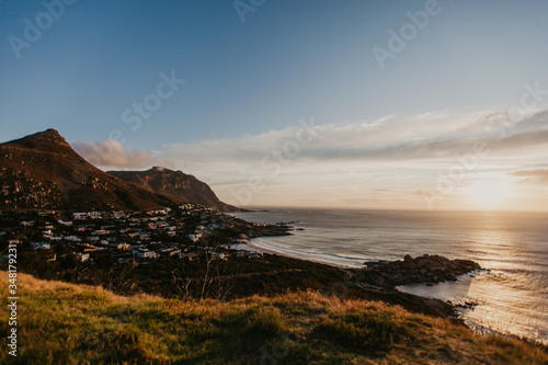 A beautiful sunset over the ocean from the top of the hill in the pristine and quaint town of Llandudno in Cape Town