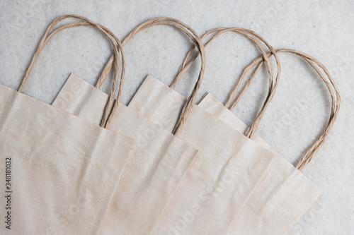 Eco friendly paper bag on white wool-like background