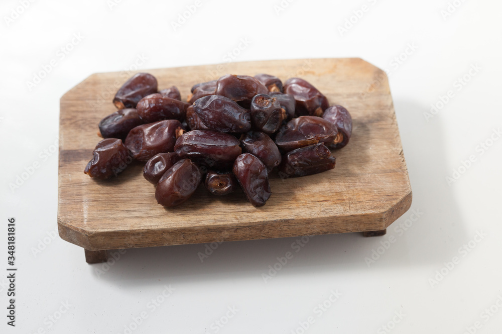Dried dates fruits on white background, tasted sweet and chewy Dried dates fruits on white background, tasted sweet and chewy