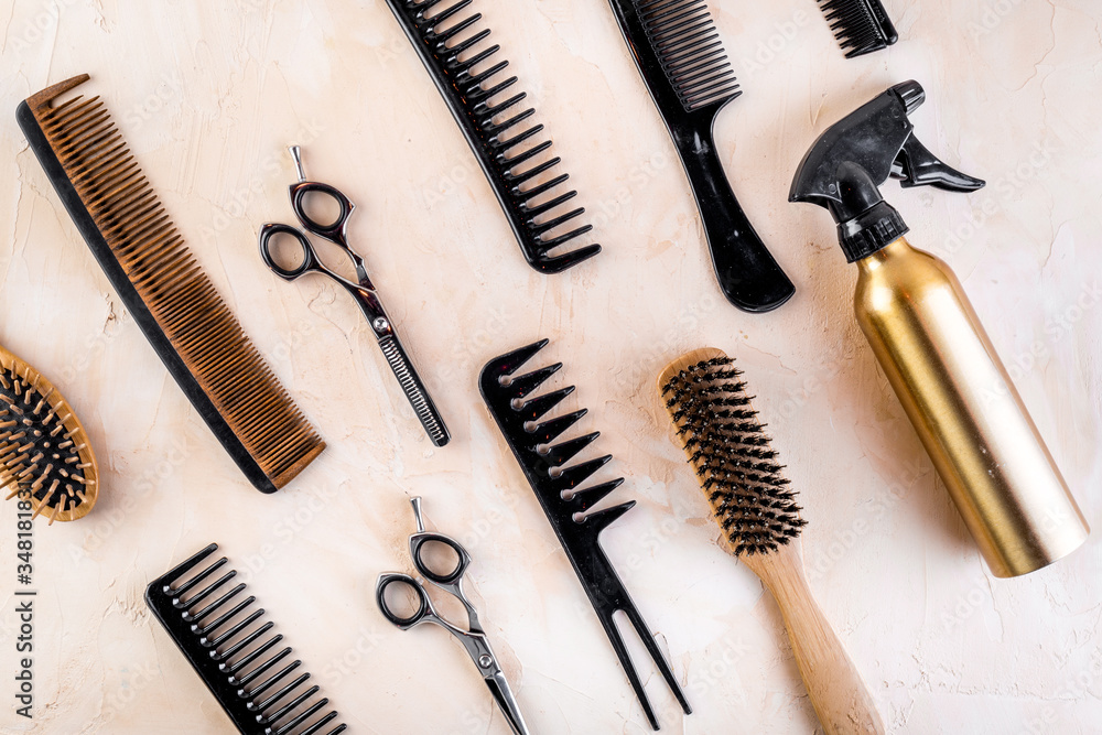 Hairdresser tools. Flat lay on beige background top view Hairdresser tools. Flat lay on beige background top view
