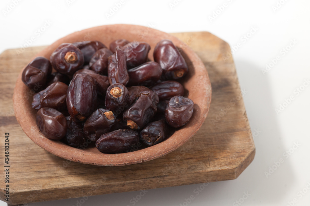 Dried dates fruits on white background, tasted sweet and chewy Dried dates fruits on white background, tasted sweet and chewy