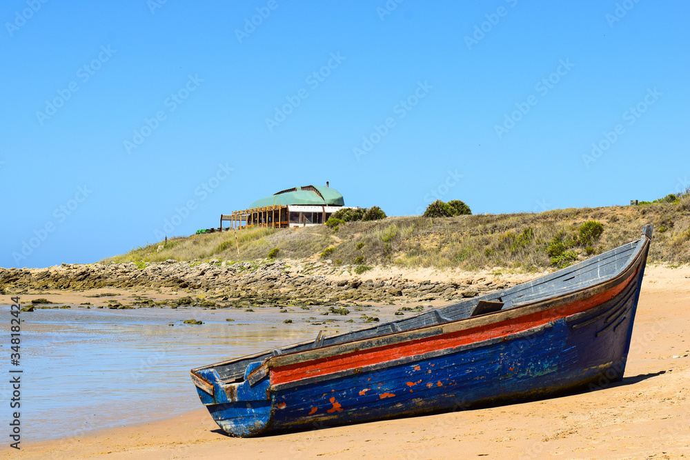 Fototapeta Immigrant dinghy boat stranded at the beach of Zahora, South Spain, near Africa.