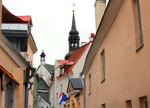 Old street in Tallinn with towers visible in the distance.