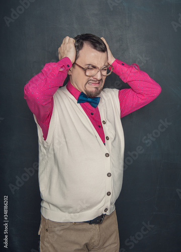 Tired funny teacher on businessman in eyeglasses on blackboard