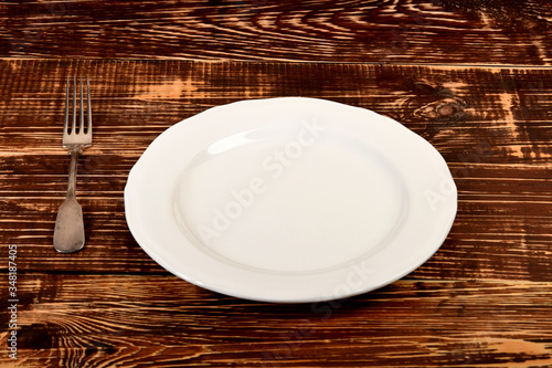 empty white plate and old retro fork