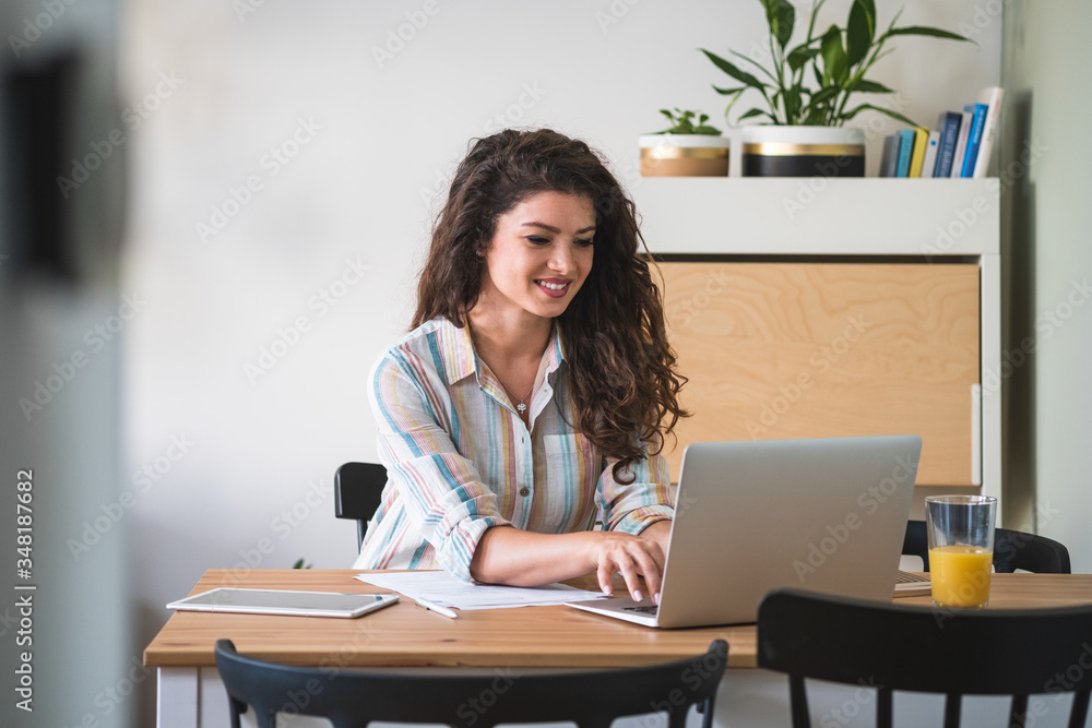 Woman working on laptop computer from home stock photo Woman working on laptop computer from home stock photo