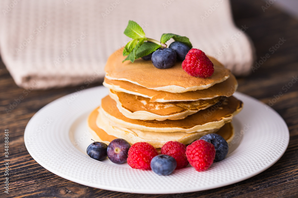 Close-up delicious pancakes with fresh blueberries and raspberries. Close-up delicious pancakes with fresh blueberries and raspberries.